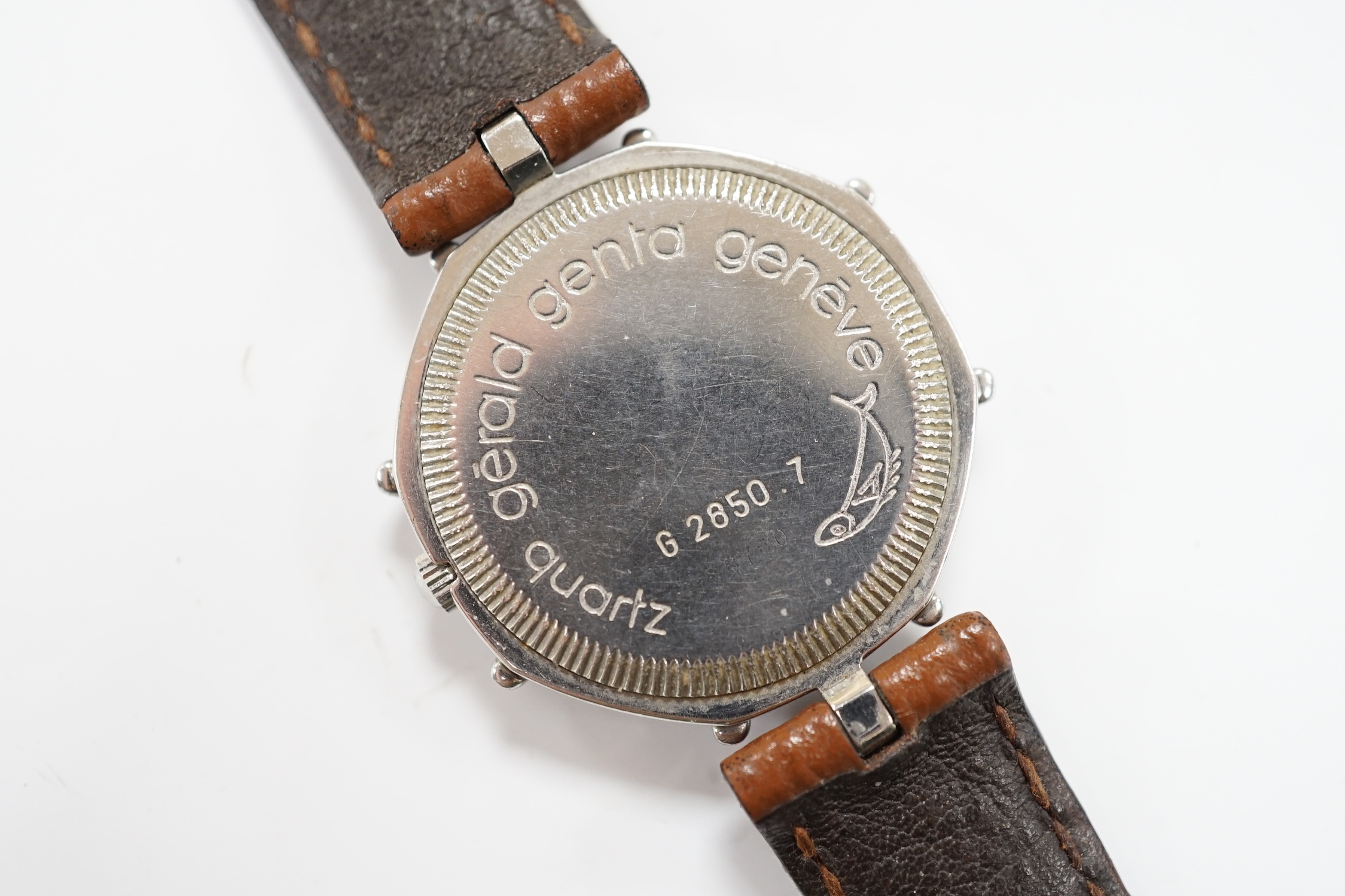 A gentleman's Swiss stainless steel Gerald Genta quartz octagonal wrist watch, with burgundy dial and Roman and baton numerals, on a leather strap, case diameter 32mm, with original box, leather pouch and guarantee.